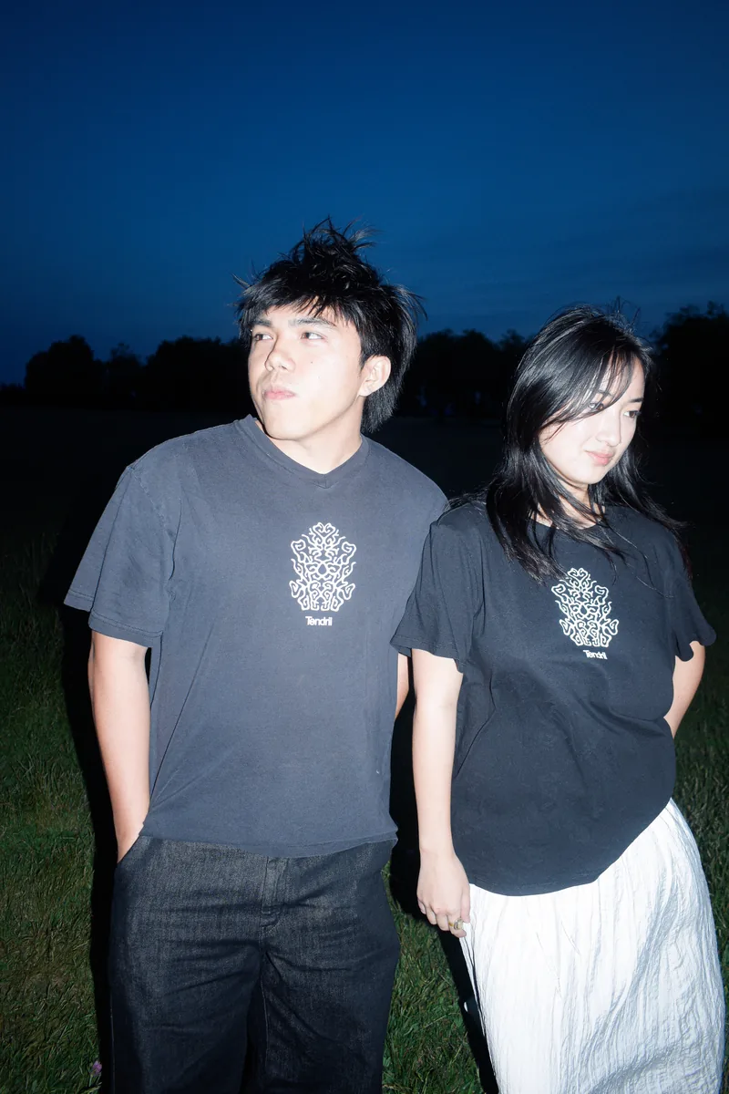 Two models wearing Tendril t-shirts at night
