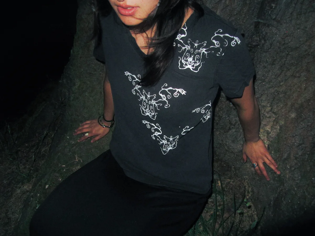 Woman in Tendril t-shirt at night
